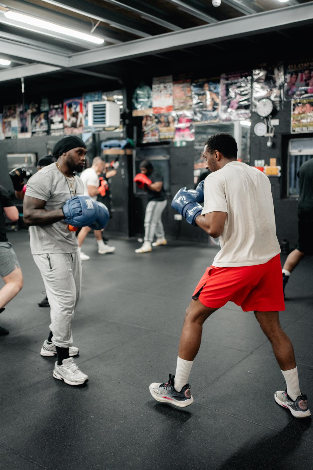 Coach and athlete in boxing stances during an LBDA strength and conditioning session