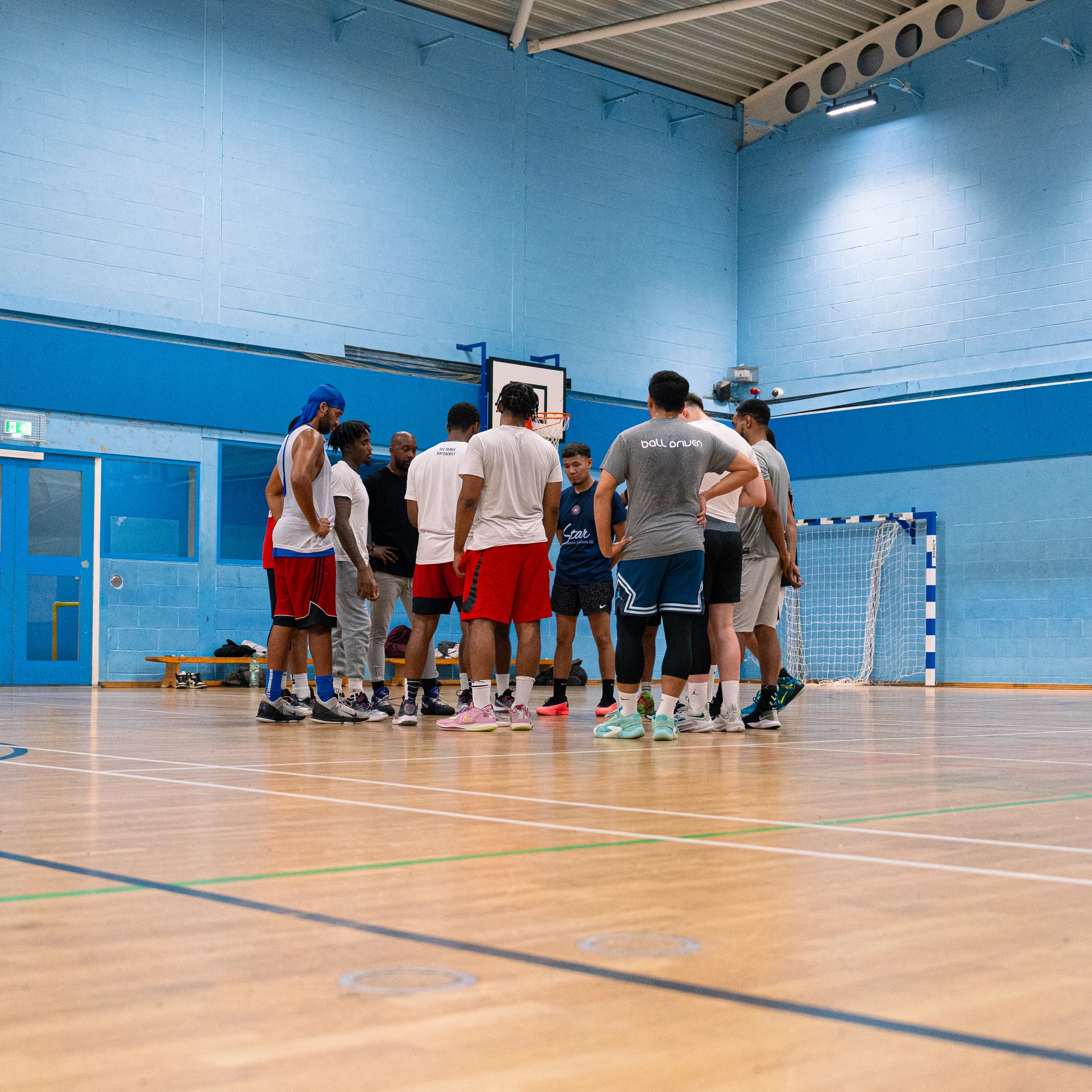 LBDA athletes in a team huddle with coaches